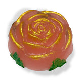 Pink rose-shaped candy with gold蕊 on a white background