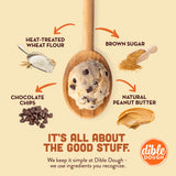 Ingredients for cookie dough displayed with a wooden spoon and Dible Dough logo.