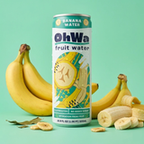 A can of OhWa fruit water banana water is centered on a mint green background, flanked by fresh and sliced bananas. The can features a white label with teal and yellow graphics and text indicating electrolytes, no added sugar, and 2C hydration from fruit.