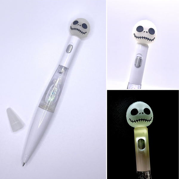 White pen with floating glitter inside and a friendly skeleton head topper that lights up with a switch. 